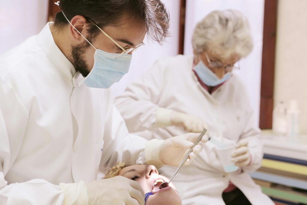 Dentists performing a dental check-up in a clinical setting with focus on dental care.